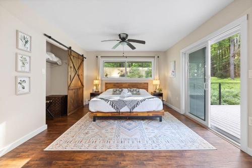 a bedroom with a bed and a window at Modern Lodge on 6 acres - 15 mins to Camelback in Cresco