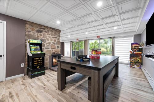 a room with a table and a video game at Modern Lodge on 6 acres - 15 mins to Camelback in Cresco