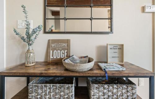 a console table with a mirror in a room at Modern Lodge on 6 acres - 15 mins to Camelback in Cresco
