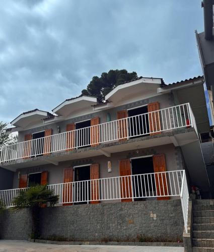 a building with orange and white balconies on it at Pousada Araucária Suítes in Campos do Jordão