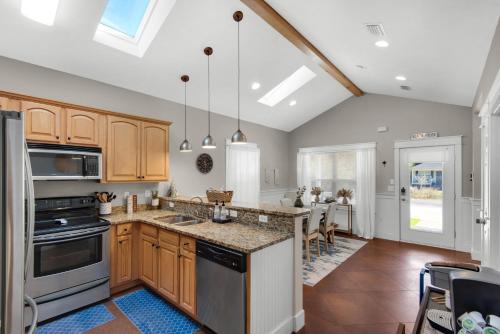 a kitchen with wooden cabinets and a kitchen island at Coastal Soul in Santa Rosa Beach