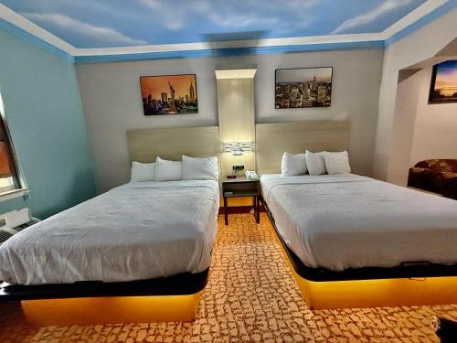a hotel room with two beds in a room at Baymont by Wyndham Texas City in Texas City