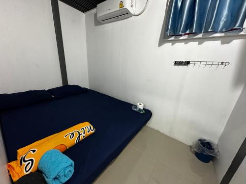 a baseball bat sitting on a bed in a room at CS Hotel Don Mueang International Airport in Don Muang Airport
