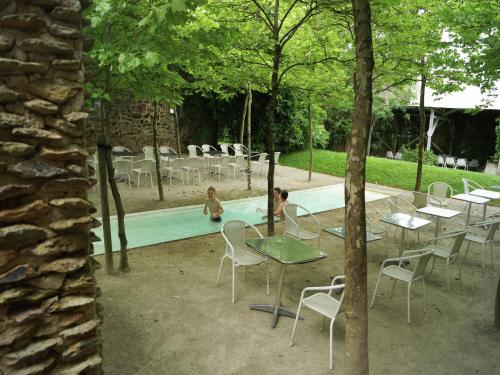 two children playing in a pool with tables and chairs at Mountain Retreat for Group in Daverdisse