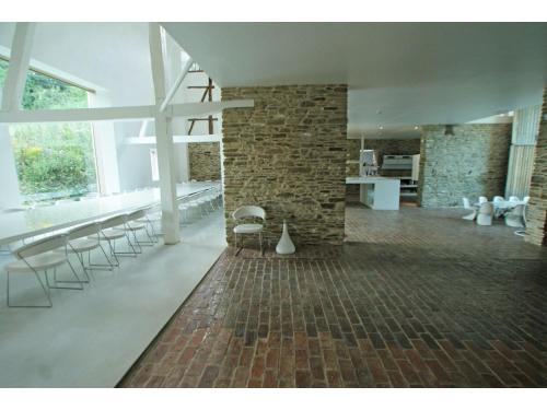 a room with chairs and a brick wall at Mountain Retreat for Group in Daverdisse