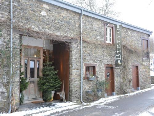 a brick building with a christmas tree outside of it at Holiday Home in Bièvre with Terrace in Bièvre