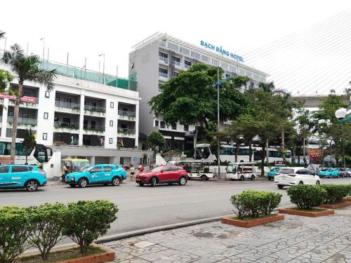 a parking lot with cars parked in front of a building at Bạch Đằng Hạ Long Hotel in Ha Long