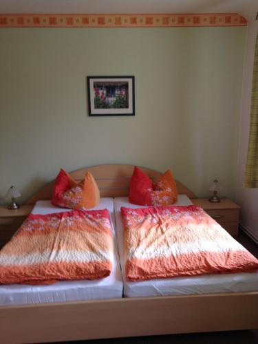 two pillows on a bed in a room at Landgasthaus am Dolgensee in Reichenwalde