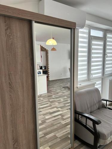 a living room with a sliding glass door with a couch at Апартаменти в центрі Трускавця in Truskavets