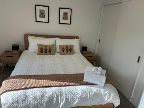 a bedroom with a large bed with two pillows at Better than the rest - Central City Luxury in Christchurch