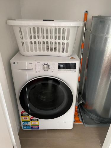 a washing machine with a basket on top of it at Better than the rest - Central City Luxury in Christchurch