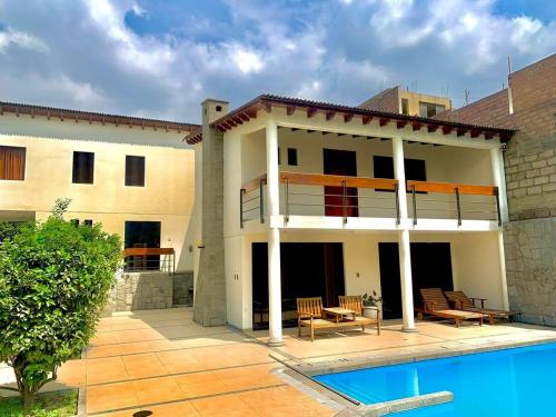 a house with a swimming pool in front of it at Casa de Campo en Santa Eulalia in Santa Eulalia
