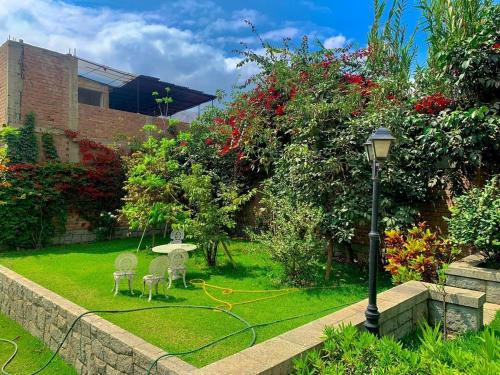 a garden with two chairs and a street light at Casa de Campo en Santa Eulalia in Santa Eulalia