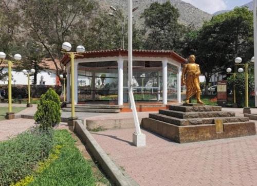 a statue of a woman in a park with a building at Casa de Campo en Santa Eulalia in Santa Eulalia