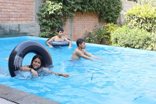 a woman and two boys in a swimming pool at Casa de Campo en Santa Eulalia in Santa Eulalia