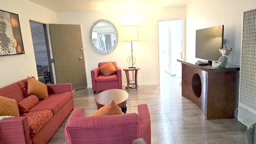 a living room with a couch and two chairs at Santa Monica Executive Suites in Los Angeles