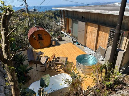 a house with a wooden deck with a gazebo at resort villa COTEAU in Konan