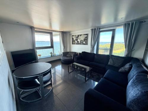 a living room with a couch and a table at Ocean Park Apartments - Oceanfront - Free Parking and Fast WiFi in Edinburgh