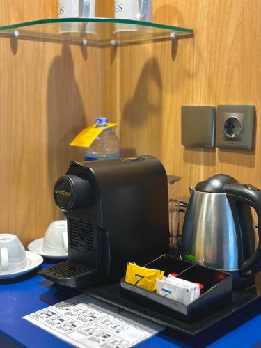 a table with a coffee maker and a tea kettle at Sevn Legian in Legian