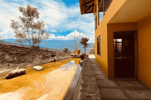 a house with a pool of water next to a building at Monteverde Best Inn - CASAS QUINTAS in Tenza