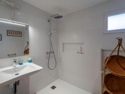 a white bathroom with a shower and a sink at Appartement T3 PMR Biscarrosse 6 Pers, Clim Parking - FR-1-319-607 in Biscarrosse