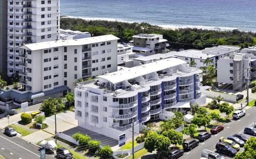 an aerial view of a building next to the ocean at Coral Sea Apartments in Maroochydore
