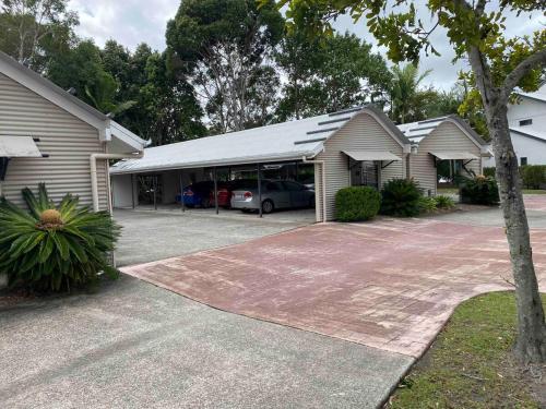 a house with a car parked in a driveway at #75 at IVORY Unique modern space with the extras in Noosaville