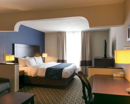 a hotel room with a bed and a desk at Comfort Suites Benton Harbor - St Joseph in Benton Harbor