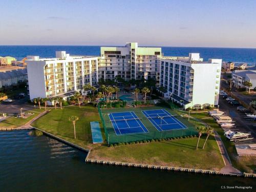 an aerial view of a hotel with a tennis court in the water at Gulf Shores Surf and Racquet Club Unit 406C in Gulf Shores