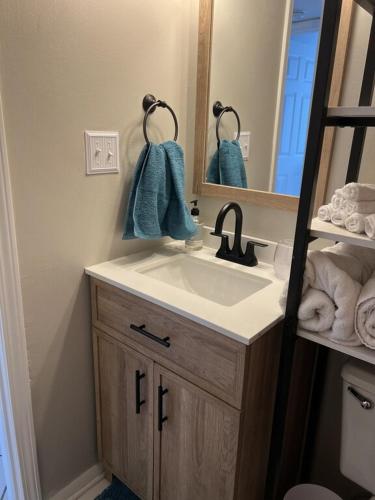 a bathroom with a sink and a mirror and towels at Gulf Shores Surf and Racquet Club Unit 406C in Gulf Shores