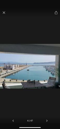 a view of a body of water from a window at Panoramic Sea View Apartment 1 Min Walk to Beach in Tangier