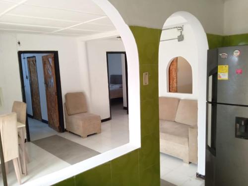 a room with chairs and a refrigerator in it at Shantyhostal in Cartagena de Indias