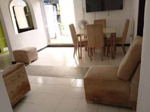 a living room with a couch and a table and chairs at Shantyhostal in Cartagena de Indias