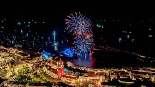 an aerial view of the magic kingdom with fireworks at Hillside apartment sunset town city in Phu Quoc