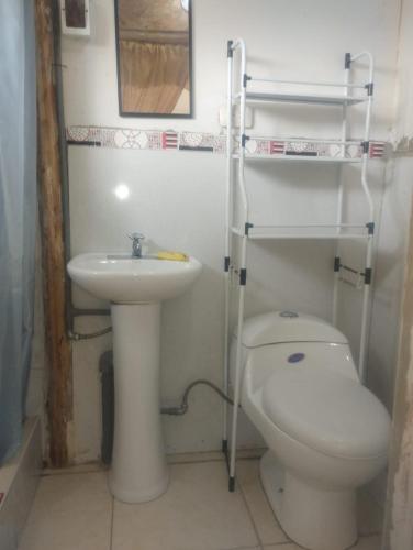 a bathroom with a toilet and a sink at LA CASA DE RICKY "El balcón de las Montañas" in Caraz