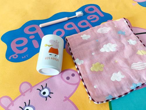 a table with a pink bear napkin and a bottle at Shangrao International Hotel in Shangrao