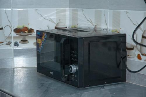 a microwave oven sitting on top of a counter at The Escape Nanyuki in Nanyuki