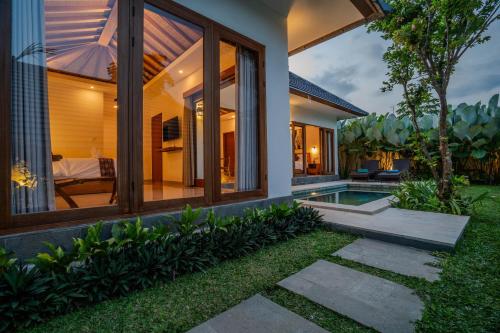 an external view of a house with a swimming pool at Arca Jungle View Luxury Villa Ubud in Ubud