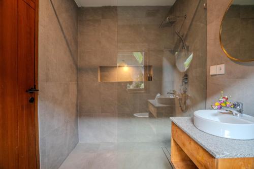 a bathroom with a sink and a shower at Arca Jungle View Luxury Villa Ubud in Ubud