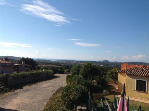 a view from the house of the road to the mountains at Villa Kuky in Santa Teresa Gallura