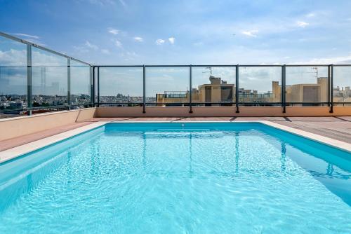 a swimming pool on the roof of a building at Olhão Beach Apartment in Olhão