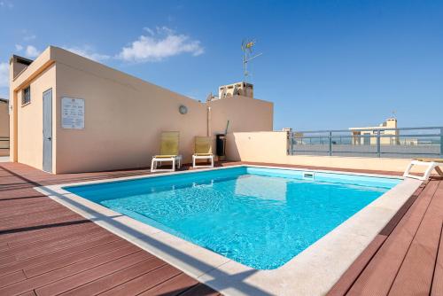a swimming pool on the roof of a building at Olhão Beach Apartment in Olhão