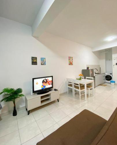 a living room with a television and a table at Studio with Rooftop Pool at Youth City Nilai by D'KAY HOMES, near USIM KLIA in Nilai