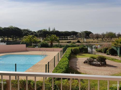 d'un balcon avec vue sur la piscine. dans l'établissement Appartement calme au Cap d'Agde pour 5 personnes, proche plage - FR-1-749-100, au Cap d'Agde