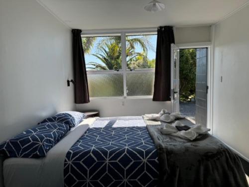 a bedroom with a bed and a large window at The Awanui Hotel in Awanui
