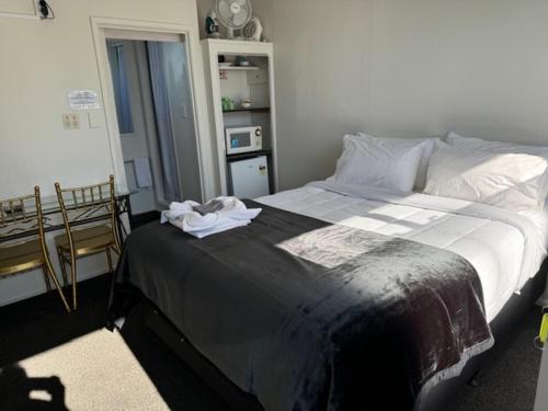 a bedroom with a large bed in a room at The Awanui Hotel in Awanui