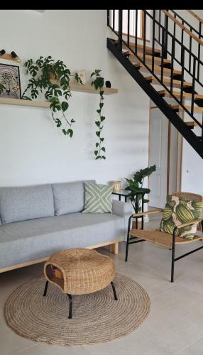 a living room with a couch and a staircase at Bambusz apartman in Balatonfůzfő