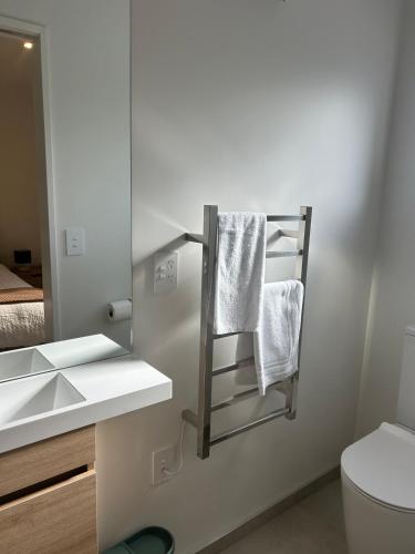 a bathroom with a towel rack and a sink at Two Units - 4 Bedrooms - 4 Bathrooms in Christchurch