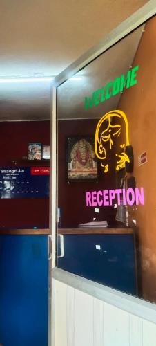 a welcome reception sign on the wall of a restaurant at Budget Friendly Rooms in Coorg in Jāmb