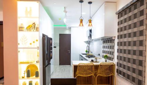 a kitchen with yellow chairs and a white counter top at kingsvilla in Trofwi